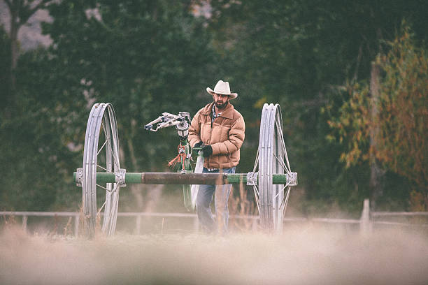 istock Hard working rancher navigates irrigation equipment across field 506690387