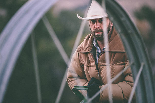 istock Intense hard working cowboy pulls irrigation equipment on farm 506690391