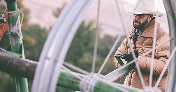 istock Close-up of hard working man pulling irrigation equipment 506690395