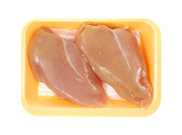istock Chicken breast on food tray 506691033