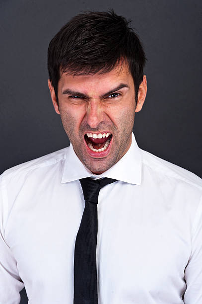 istock angry businessman over dark background 506691079