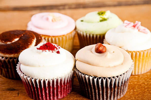 istock cupcakes on wooden background 506692279