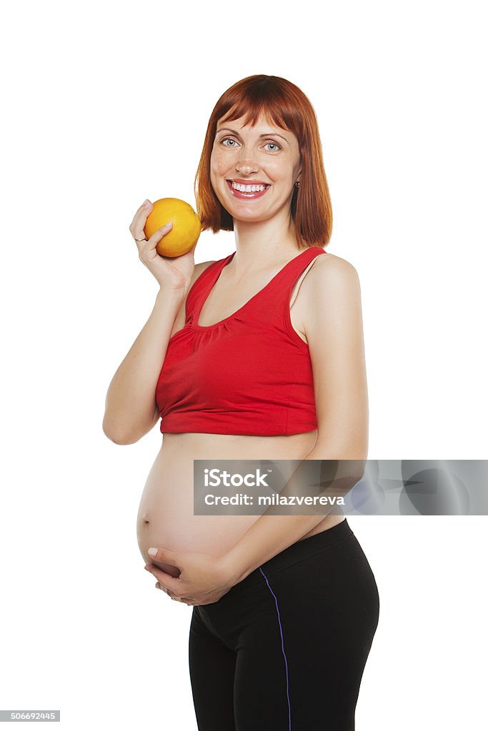 pregnant woman and orange. isolated on a white background pregnant girl holding an orange. on white background Abdomen Stock Photo