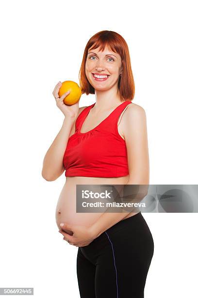 Pregnant Woman And Orange Isolated On A White Background Stock Photo - Download Image Now