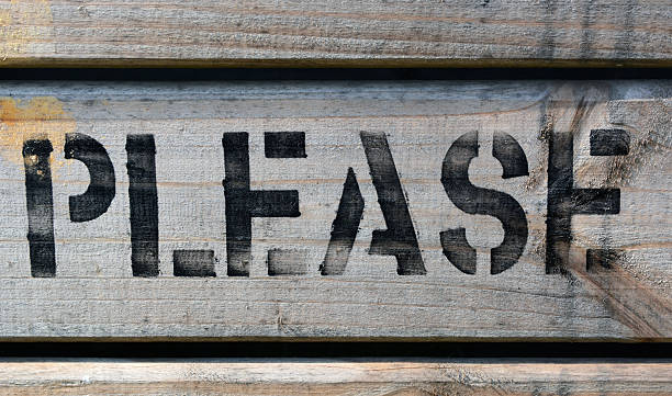 istock PLEASE stencilled in capitals on wood 506692933
