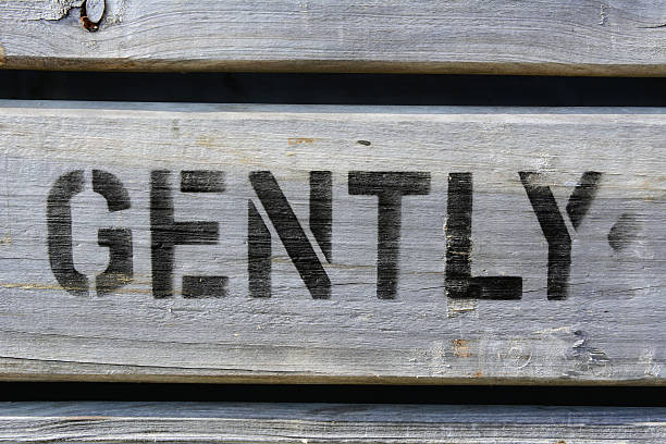 istock GENTLY stencilled in capitals on wood 506692935
