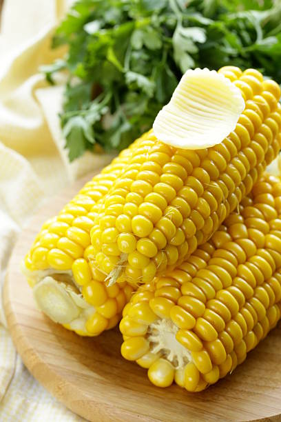 istock fresh boiled cob corn on a wooden plate 506693773