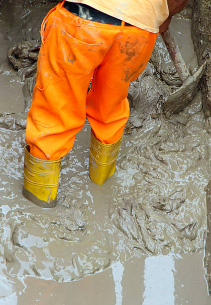istock worker boots in brown mud during the flood 506694733