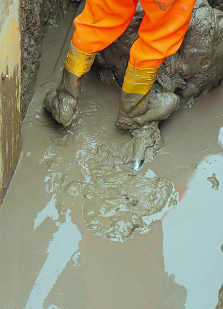 istock worker boots in brown mud during the flood 6 506694859