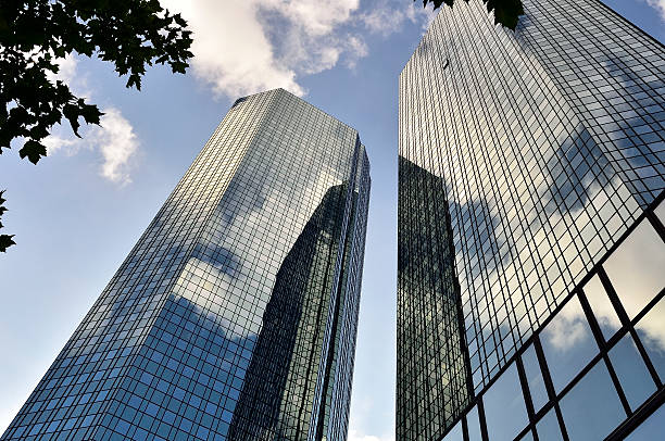 istock Modern office building facade with reflecting clouds - Deutsche Bank 506694951