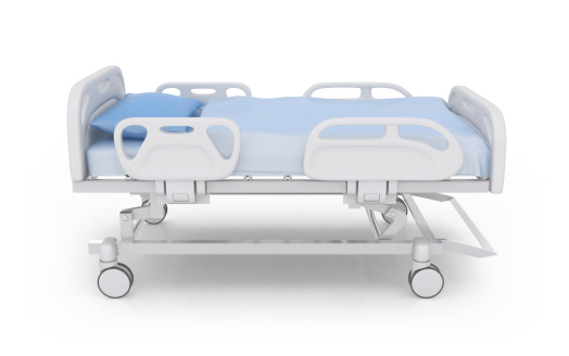 Surgical bed on wheels over white background