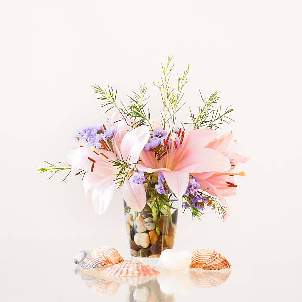Artistic flower arrangement in a vase on a glossy table