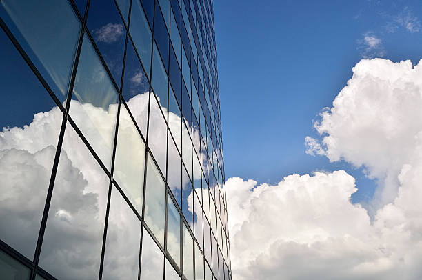 istock Modern office building glass facade with reflecting clouds 506695999