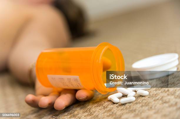 A Hand At The Floor Holding A Box With Drugs Stock Photo - Download Image Now - Addiction, Adult, Adults Only