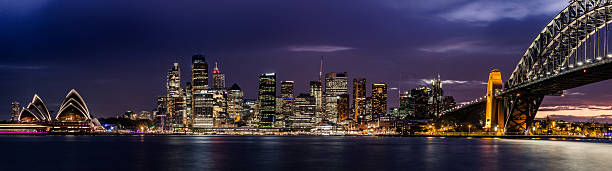 porto de sydney cbd, iluminada à noite - sydney australia skyline city panoramic - fotografias e filmes do acervo