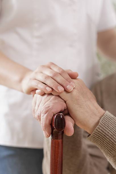 istock Kind caregiver holding senior man 506700284