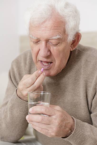 istock Senior male taking pill 506700754