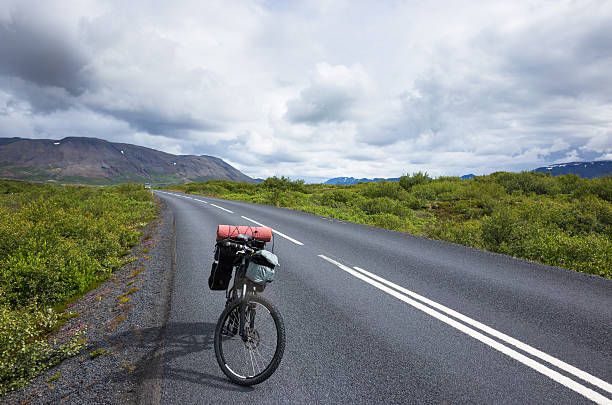 istock Biker rides on road at sunny summer day in Iceland 506701432