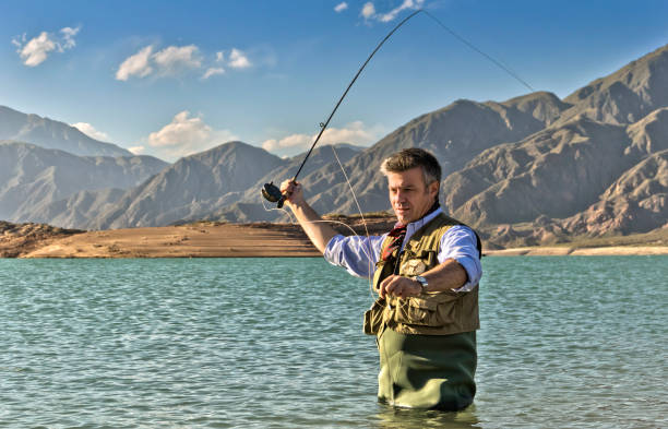 Fly fishing on lake for catching trout. Mendoza, Argentina.