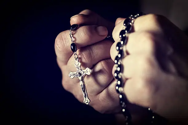 closeup image of hands and rosary