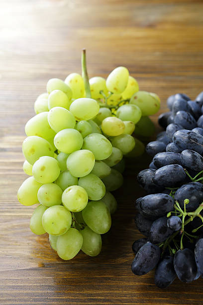 istock branches of ripe green and blue grapes 506704080