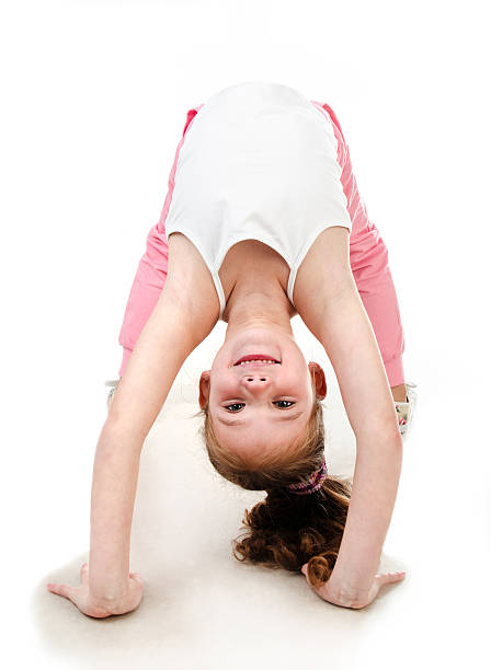 istock Cute little girl doing gymnastic exercise 506704212