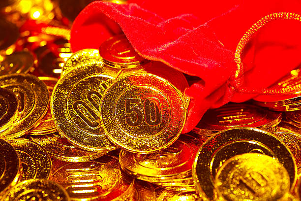 istock From red sack scattered pile of gold coins 506705374
