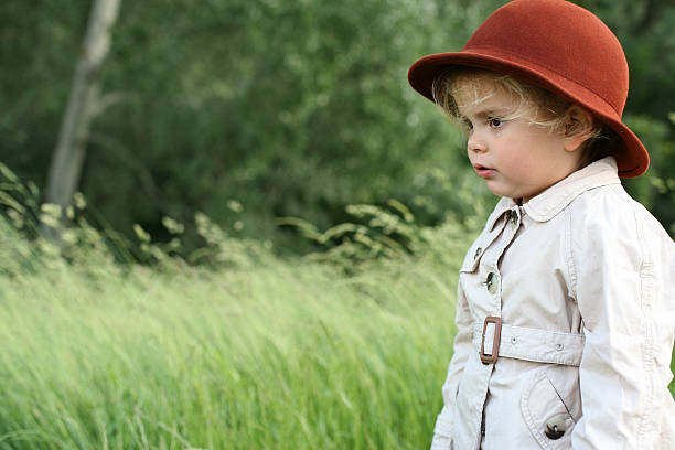 istock Little girl on windy day. Space for copy. 506705660