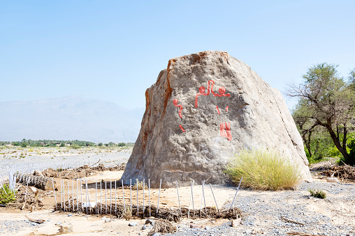 Image of the famous Colemans Rock in Oman with highlighted old pictures of people