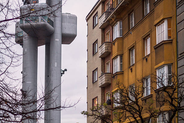 Prague, Czech Republic - December 21, 2015: TV-Tower in Prague-Zizkov near an traditional residential building of the 1940'ies.