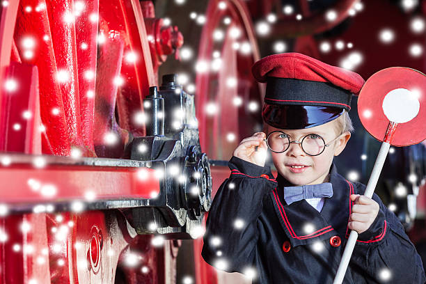 istock Smiling Train Conductor Boy in Winter 506711676