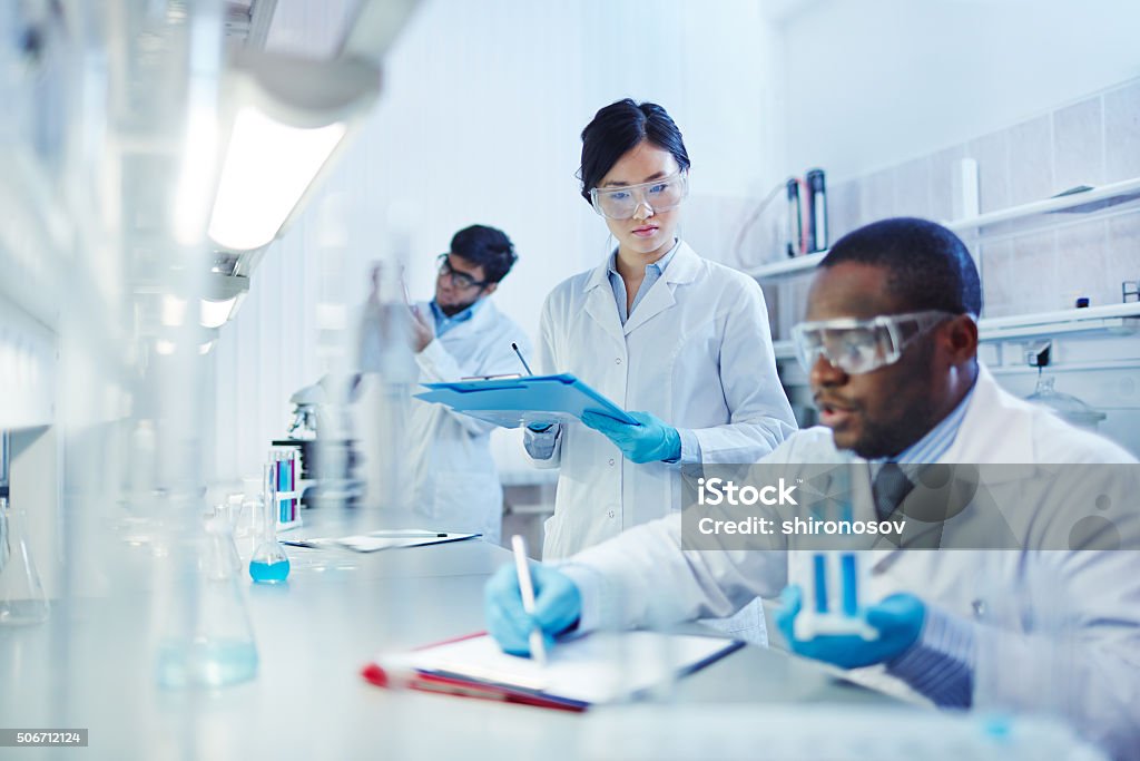 Working in laboratory Young scientists analyzing substances in laboratory Laboratory Stock Photo