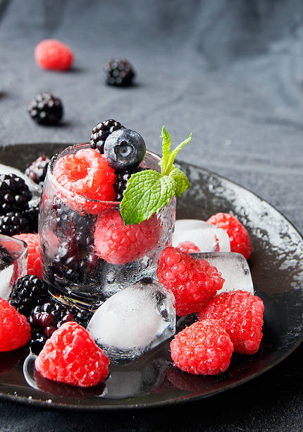 istock black berries and raspberries in a glass cup 506712290