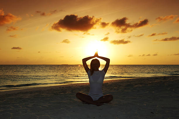 istock sunset yoga woman 506712311