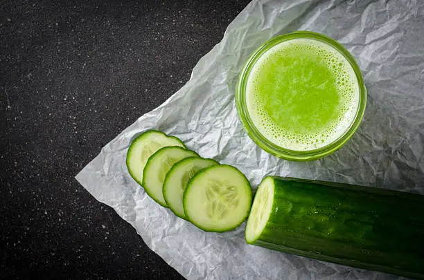 Cucumber juice on dark background