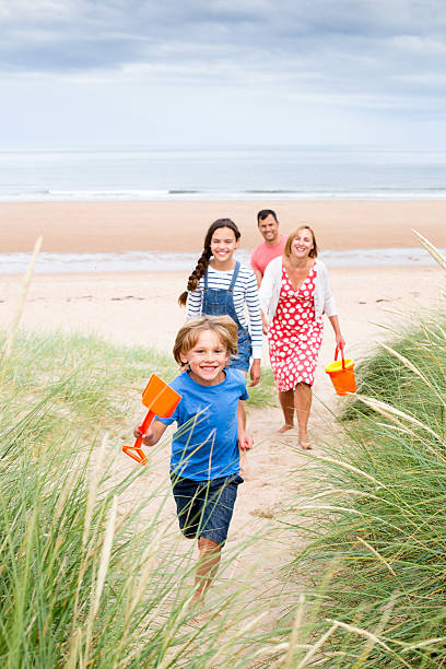 istock Family walking up the sand dunes 506713894