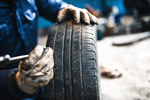 car tire repairmen with caliber