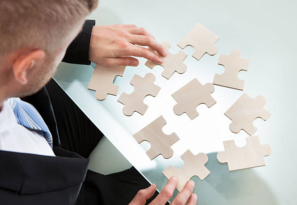 istock Businessman with a jigsaw puzzle 506714819