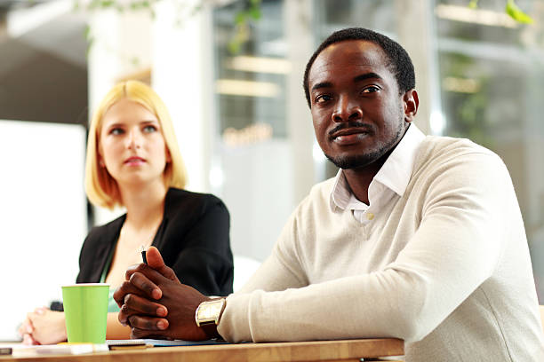 istock Business people sitting around a table during 506715669