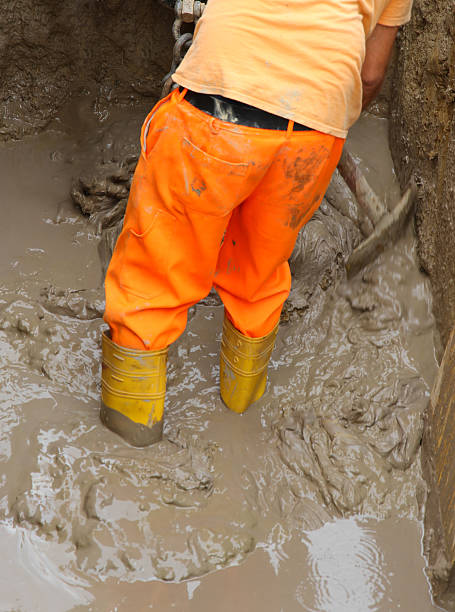 istock worker boots in brown mud during the flood 2 506716711
