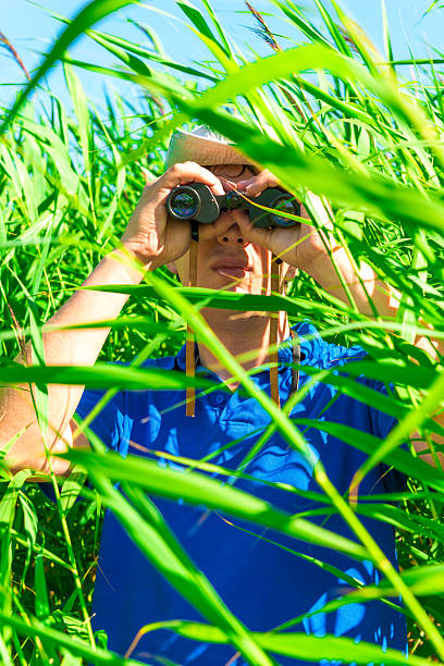 istock vertical shot of a man with binoculars 506724765