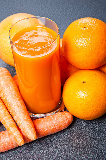 istock Orange and carrot juice in glass 506727239