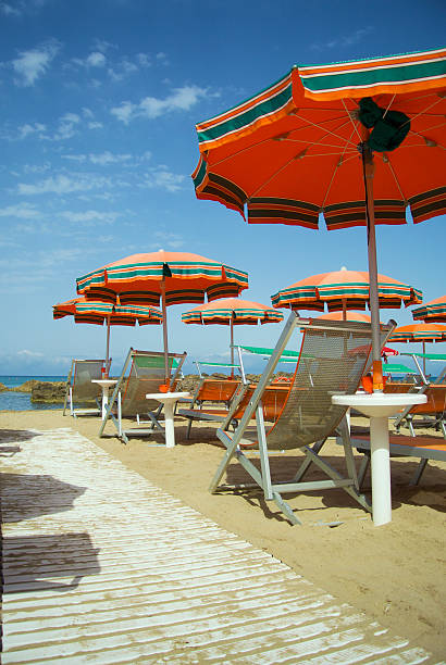 Beach with umbrellas and chairs stock photo