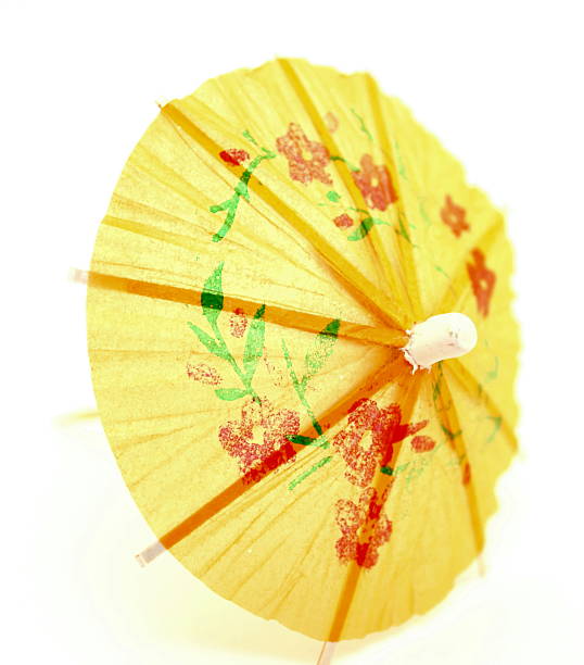 istock Yellow cocktail umbrella on white background closeup 506727569
