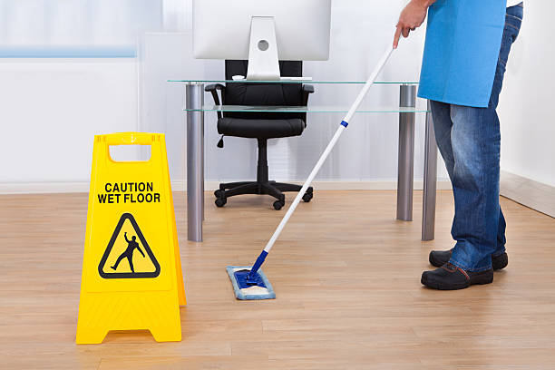 istock Warning notice as a janitor mops the floor 506729107