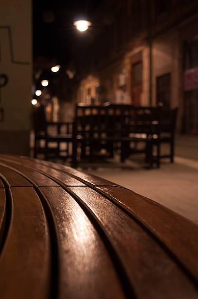 istock narrow street and a bench at night 506729373