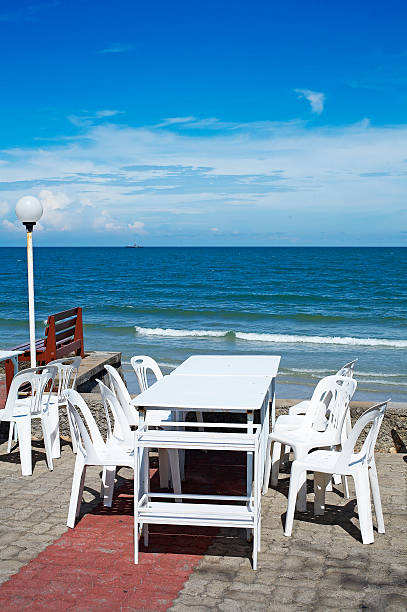 istock white chair and table on beach 506729447