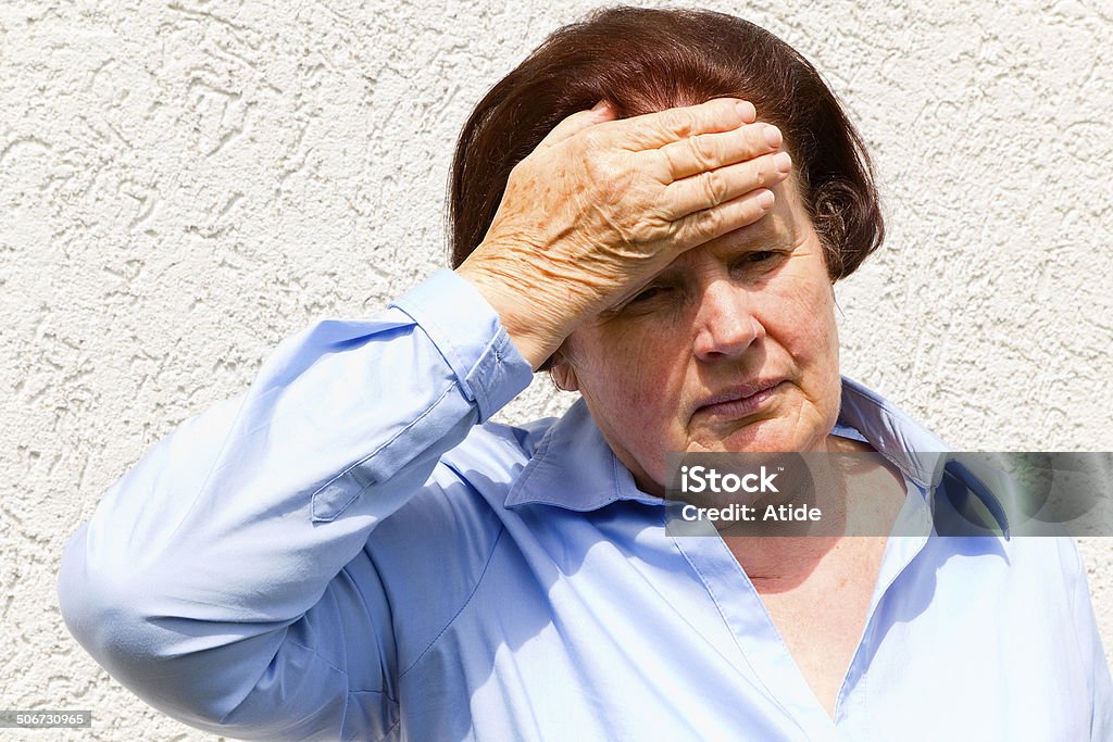 Headache Portrait of sad senior woman with headache. Adult Stock Photo