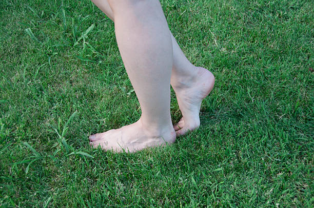 istock Woman legs on green grass 506731571