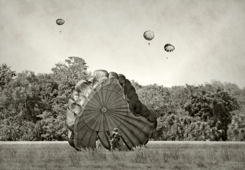 World War 2 era soldiers landing on a field